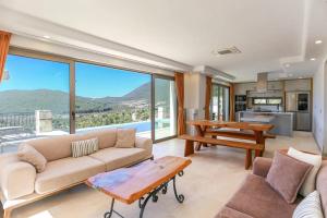 a living room with a couch and a table at Villa Sydney in Kaş
