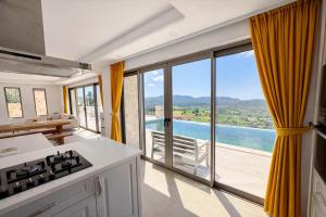 a kitchen with a view of the ocean at Villa Sydney in Kaş