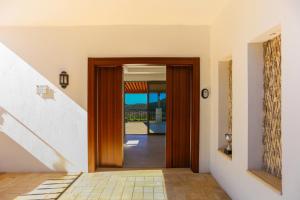 a hallway with a wooden door and a staircase at Villa Sydney in Kaş