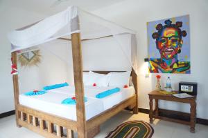 a bedroom with a bed with a canopy at Cocolala Beach House in Nungwi