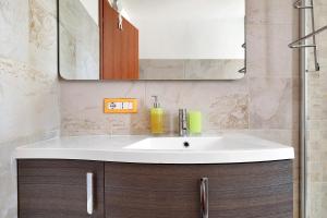 a bathroom with a sink and a mirror at Casa Beccari in Cala Liberotto