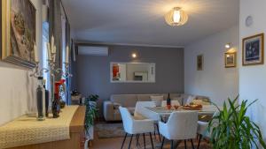 a dining room and living room with a table and chairs at Villa Emanuela by Villas Guide in Grubine