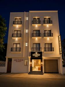 a white building with a sign on the front of it at The Kingsway Suites in Nagpur