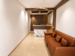 a living room with a couch and a kitchen at The Kingsway Suites in Nagpur +11 photos