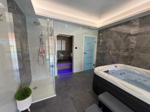a large bathroom with a tub and a shower at Apartman Cherry in Višnjevac