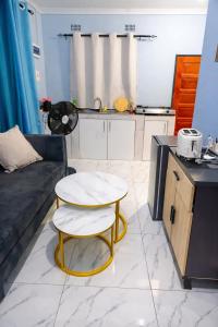 a living room with a table and a couch at Peaceful Home Self-catering Solar Backed Apartment in Lusaka