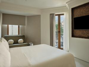 a bedroom with a white bed and a window at The Newel Kolonaki in Athens