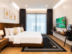 a bedroom with a large bed and a tv at YUSETH Private Villa in Phumi Ta Phul +19 photos