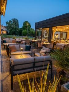 a patio with couches and tables and tablesearcher at Central in Casarile