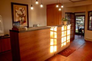 a kitchen with a bar with lights on it at Adem Gasteplaas & Function Venue in Kroondal