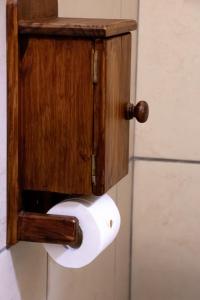 a toilet paper dispenser attached to a wall at Adem Gasteplaas & Function Venue in Kroondal