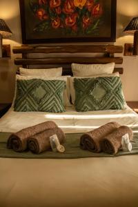 a bed with three rolls of towels on it at Adem Gasteplaas & Function Venue in Kroondal +36 photos
