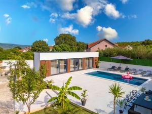 a villa with a swimming pool and a house at Villa Sunshine in Pridraga