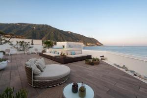 a patio with couches and a view of the ocean at La Chiaja art&relais in Castellammare di Stabia