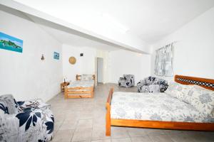 a living room with a couch and a bed at THE BAY in Trou d'Eau Douce +43 photos