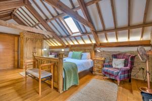 a bedroom with a bed and a chair at Finest Retreats - Jabajak Vineyard in Whitland