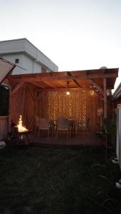 a patio with a table and chairs and a fire at Şimal Bungalov in Samsun