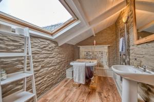 a bathroom with a sink and a skylight at Finest Retreats - Jabajak Vineyard in Whitland +41 photos