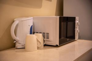 a microwave sitting on top of a counter at Palace Lodge Morningside in Durban