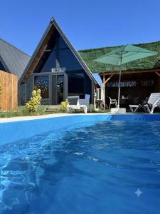 a house with a swimming pool in front of a house at Şimal Bungalov in Samsun