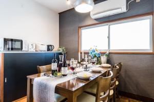 a dining room with a table with wine bottles at Gran kodachi in Fujikawaguchiko +26 photos