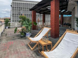 a couple of chairs sitting on a patio at Belivin99 Residence Chinatown in Bangkok
