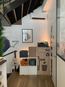 a room with a kitchen with a table and a refrigerator at Espace entier Centre de Paris in Paris