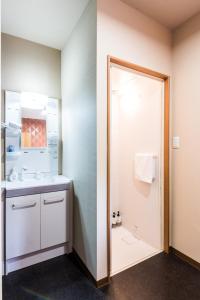 a bathroom with a sink and a shower at Gran kodachi in Fujikawaguchiko