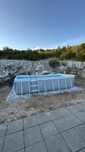 a pool is laying on the ground next to a sidewalk at Studio Apartment Sanja 4 in Neum
