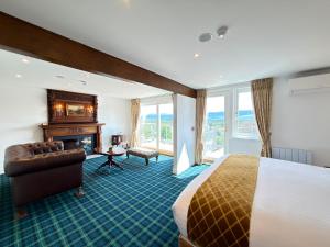 a hotel room with a bed and a fireplace at Grant Arms Hotel in Grantown on Spey +77 photos