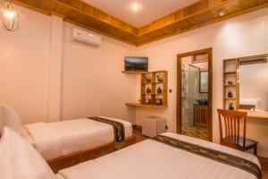 Postel nebo postele na pokoji v ubytování BB Angkor Residence