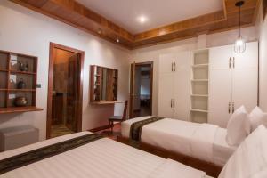 Postel nebo postele na pokoji v ubytování BB Angkor Residence