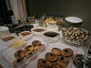 a table topped with trays of donuts and other food at Musa Hotel in Yeghegis +21 photos