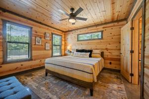 a bedroom with a bed and a ceiling fan at Private Escape| Hot tub| Fire Pit| Trail Access in Broken Bow