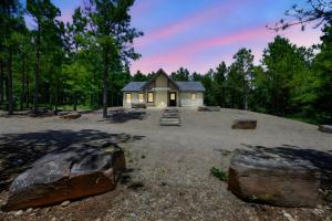a small house in the middle of a forest at Private Escape| Hot tub| Fire Pit| Trail Access in Broken Bow