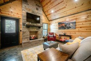 a living room with a couch and a fireplace at Private Escape| Hot tub| Fire Pit| Trail Access in Broken Bow