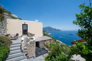 a house on the cliff with a view of the ocean at Villa Alba - Amalfi Coast in Amalfi