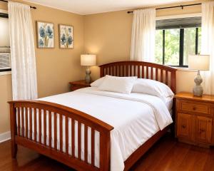 a bedroom with a large bed and a window at The Country Barn in Port Alberni