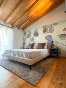 a bedroom with a bed in a room with a wall at Agriturismo Camerin - CL Agri Lounge in Conegliano