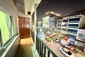 a view of a city street at night from a balcony at Baan at Khaosan Hotel in Bangkok