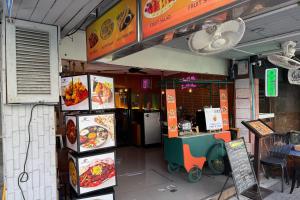 a fast food restaurant with refrigerators and a counter at Baan at Khaosan Hotel in Bangkok