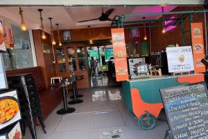 a fast food restaurant with a counter with a pizza at Baan at Khaosan Hotel in Bangkok +12 photos