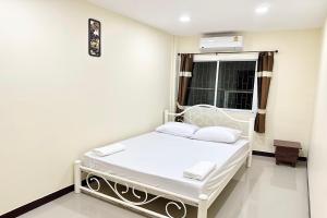 a hospital bed in a room with a window at Baan at Khaosan Hotel in Bangkok