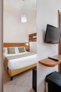 a bedroom with a bed and a tv on a wall at Hotel Moscatello in Rome
