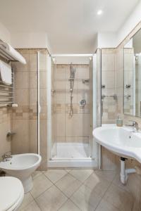 a bathroom with a shower and a toilet and a sink at Hotel Moscatello in Rome +21 photos