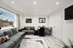 a living room with a couch and a table at K Suites - Nuxley Road in Bexley