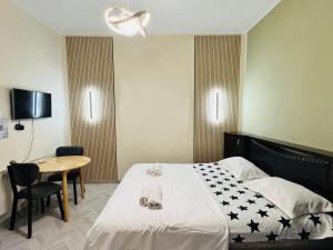 a hotel room with a bed and a table and a chair at Old Rabati in Akhaltsikhe