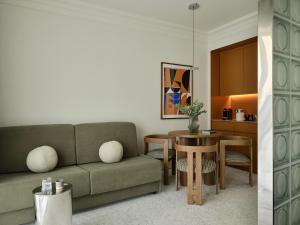 a living room with a couch and a table at The Newel Kolonaki in Athens