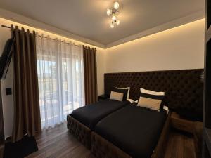 a bedroom with a bed and a large window at Mamica Luxury Villa in Laganas +37 photos