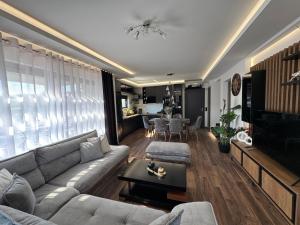 a living room with a couch and a table at Mamica Luxury Villa in Laganas